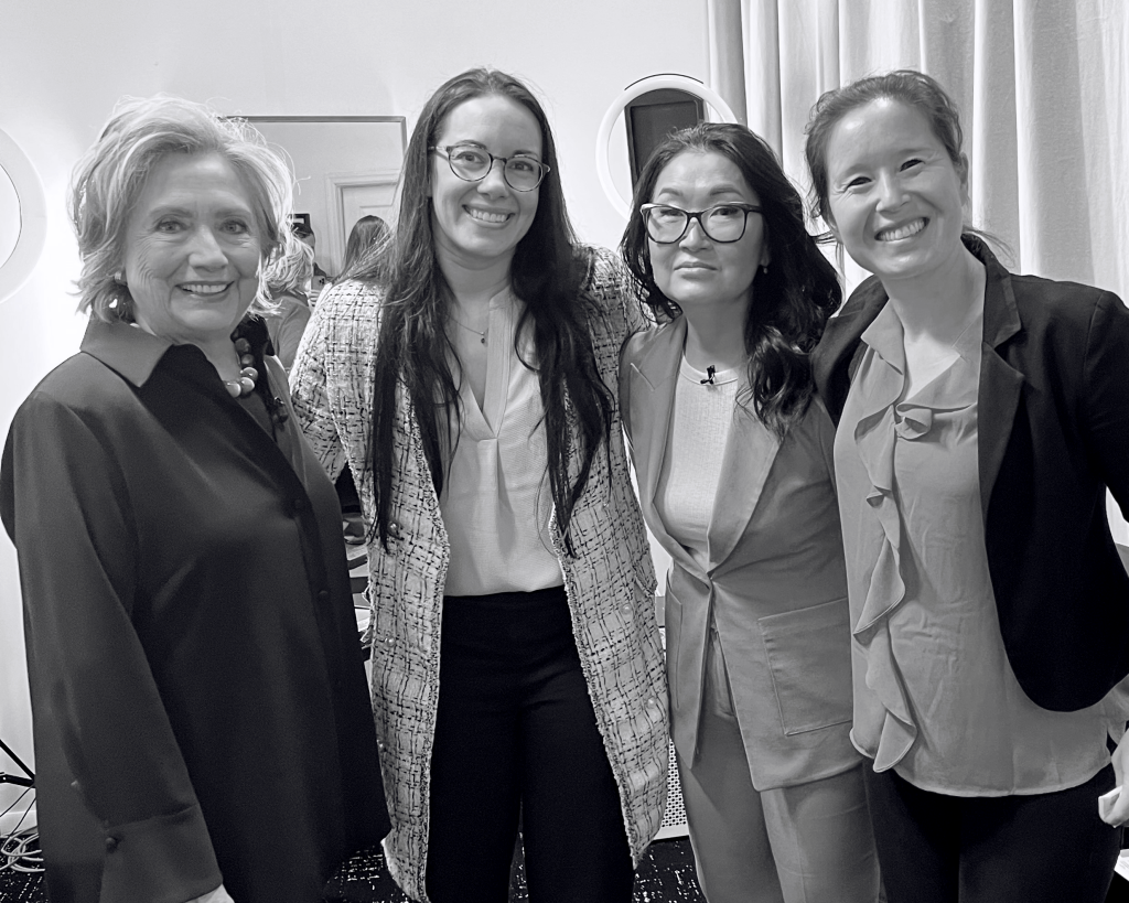 Black-and-white photo of Melissa standing with three colleagues at a professional event.